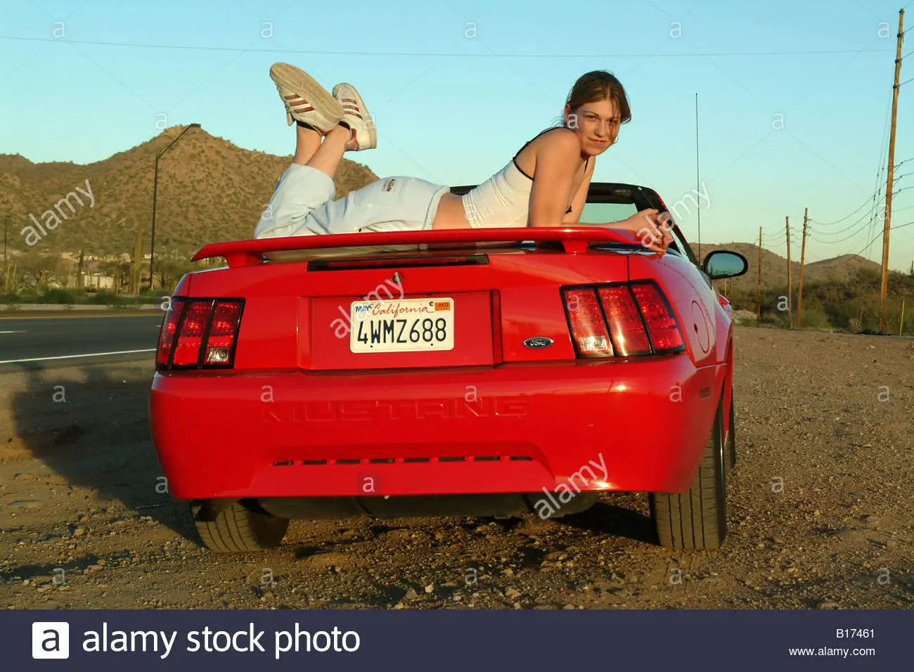 girl-posing-on-red-mustang-car-in-arizona-b17461.webp