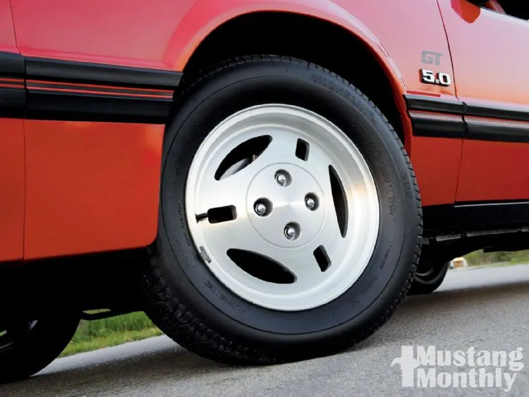 mump_1102_11_o+1984_ford_mustang_gt_convertible+front_driver_side_wheel.webp